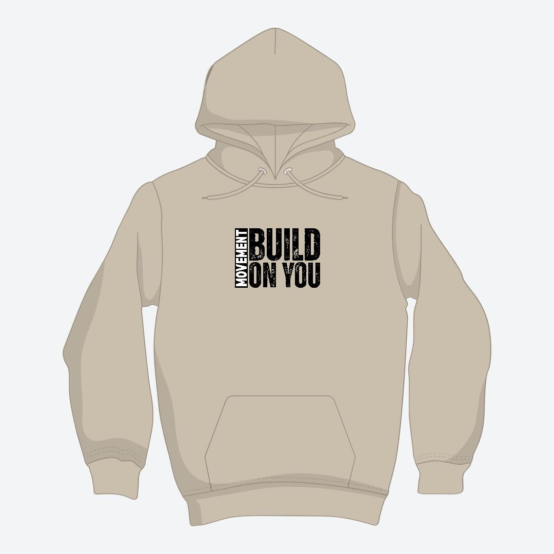 Beige hoodie with text 'MY HEART BUILD ON YOU' on a white background